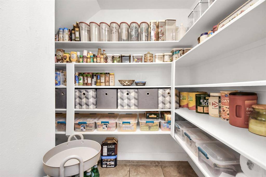 The walk-in pantry is a meticulously designed space that combines functionality with elegance, offering ample storage and easy access to food and kitchen essentials.