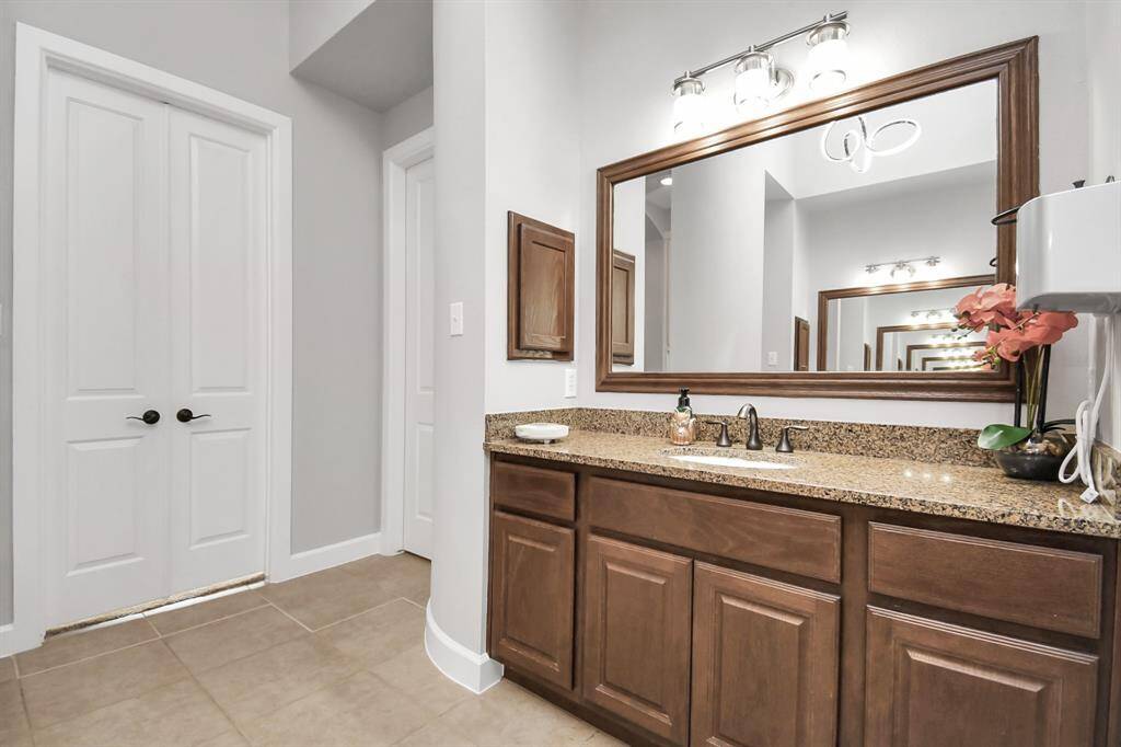 The master bathroom is thoughtfully designed with distinct sink areas for each partner, enhancing convenience and privacy. Each area is elegantly appointed, ensuring that both sinks are functional and aesthetically pleasing.