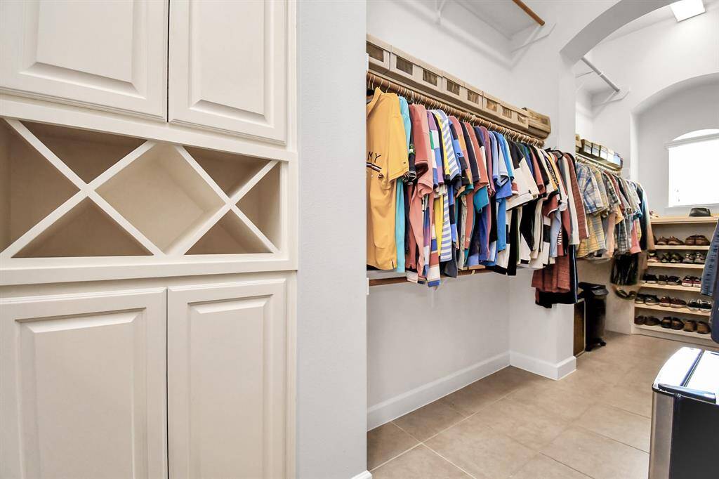 A walk-in closet or custom wardrobe provides ample storage for clothing and accessories. The closet is designed with built-in shelving, hanging racks, and drawers, offering organized and easy access to personal items.