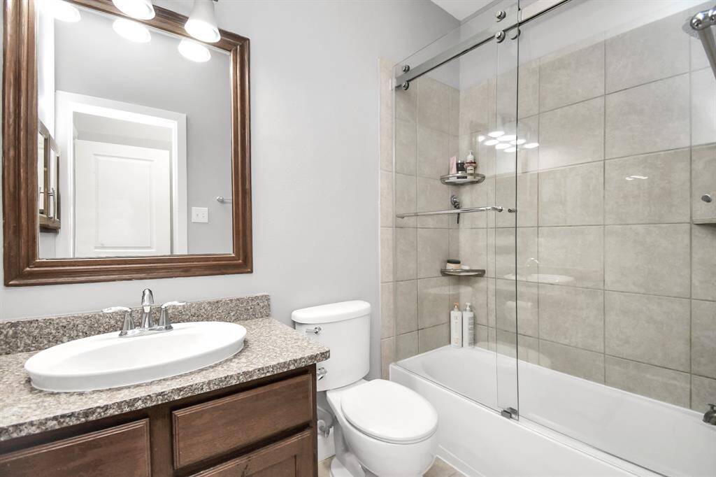 The second bathroom, with its glass shower doors, combines modern design with practical features to create a luxurious and inviting space. The thoughtful layout, high-quality finishes, and elegant details ensure that the bathroom is both functional and stylish, providing a sophisticated retreat within the home.