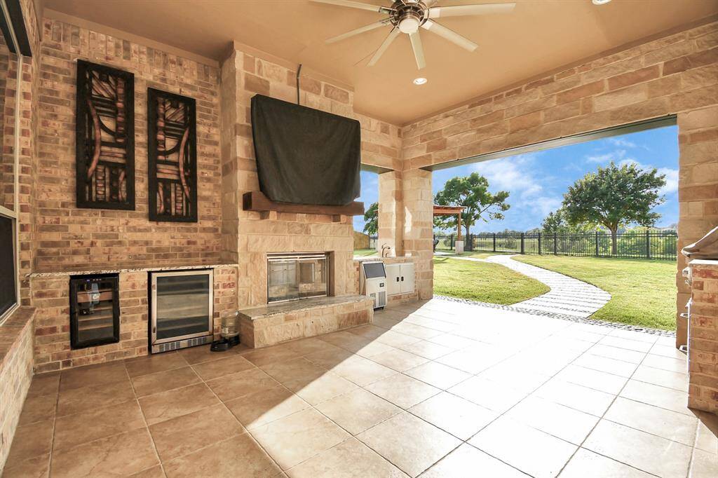 This grand outdoor kitchen is designed to be a luxurious and functional space for cooking, dining, and entertaining while enjoying breathtaking views. It combines high-end appliances with stylish features to create a versatile area for outdoor gatherings and culinary experiences.