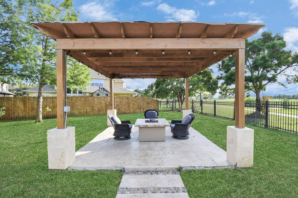 This luxurious outdoor pergola is designed to offer a sophisticated and comfortable space for relaxation and entertaining. Featuring a central fire pit, it combines style and functionality, creating a warm and inviting atmosphere for any outdoor gathering.