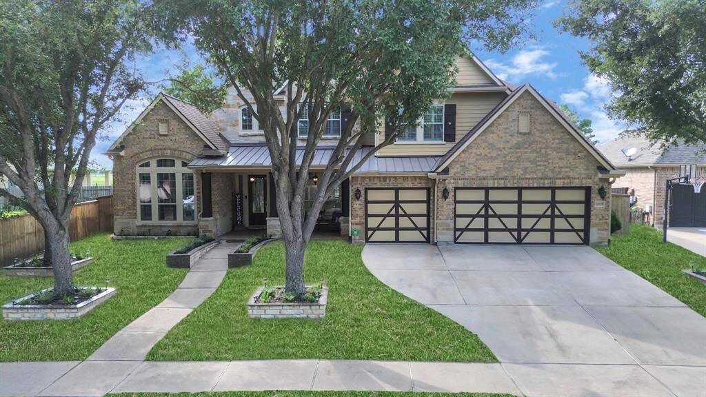 Flanking the entrance, meticulously manicured gardens showcase a symphony of colorful blooms and lush greenery, adding a vibrant touch to the meticulously designed landscape.