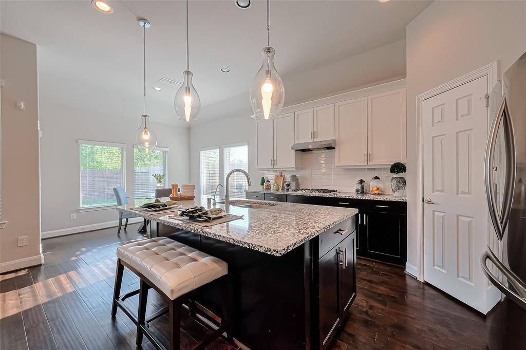 This family room offers a seamless open-concept design flowing naturally into the kitchen and dining area, making it the heart of the home.