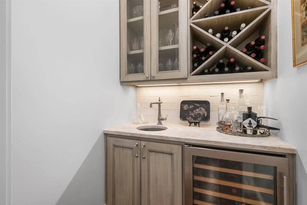 WINE BAR - Wine bar off the dining room with custom built-in wine storage cabinets and wine refrigerator.