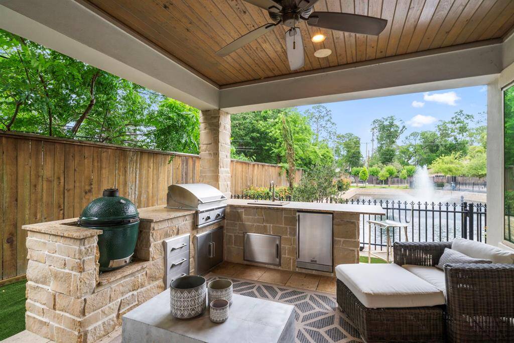 CUSTOM DESIGNED OUTDOOR KITCHEN - A tranquil outdoor patio that is your own private retreat. Includes a built in gas grill, sink, and refrigerator.