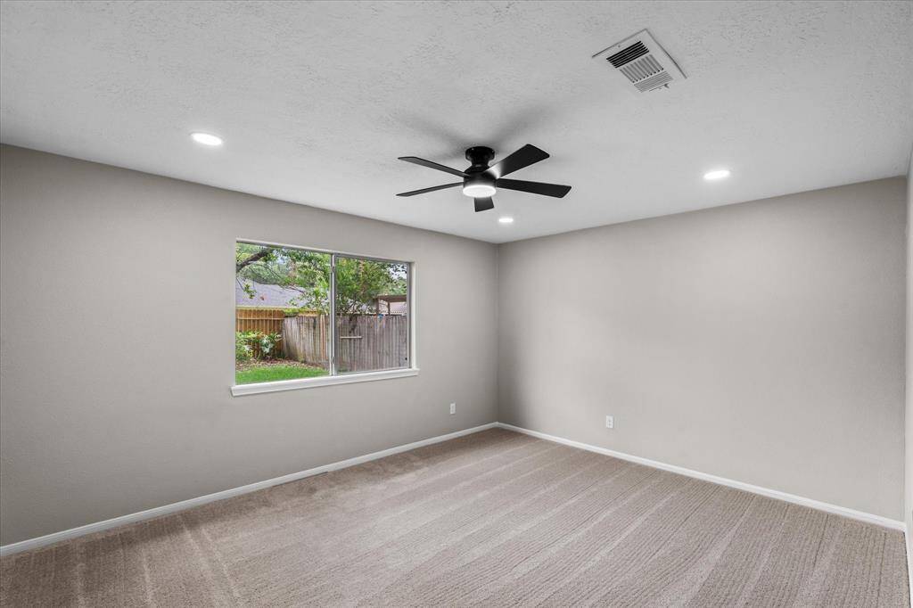 Primary bedroom with recessed lights and fan with remote control