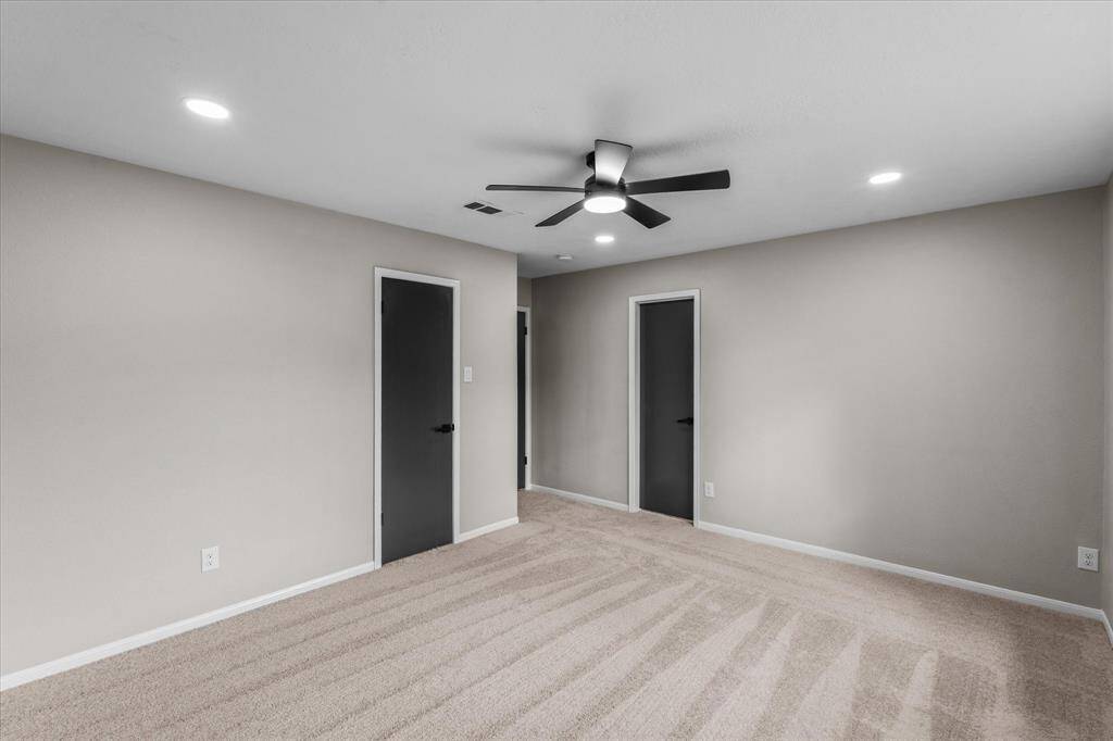 Another view of the primary bedroom
