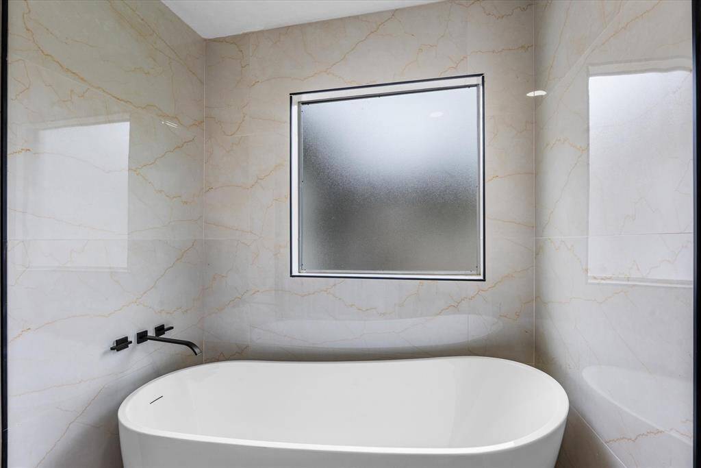 Freestanding soaking tub in the primary bath