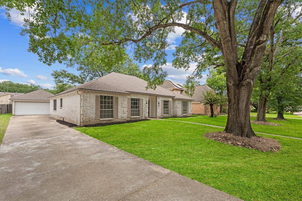 Extra long driveway with detached 2 car garage in the back of the house