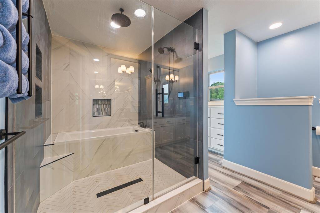 Gorgeous primary bathroom with oversized walk-in shower and tub area