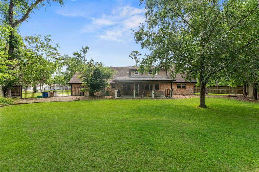 Huge backyard with covered patio and fire pit