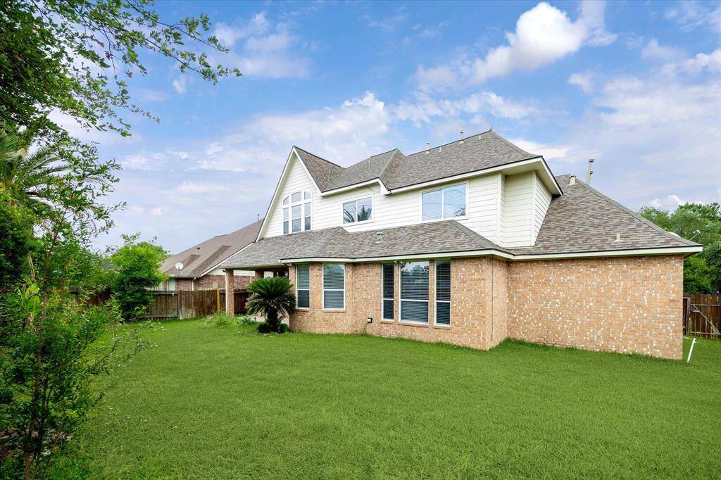 large backyard with brick wall separating from Queenston blvd road and the Golf Cource.