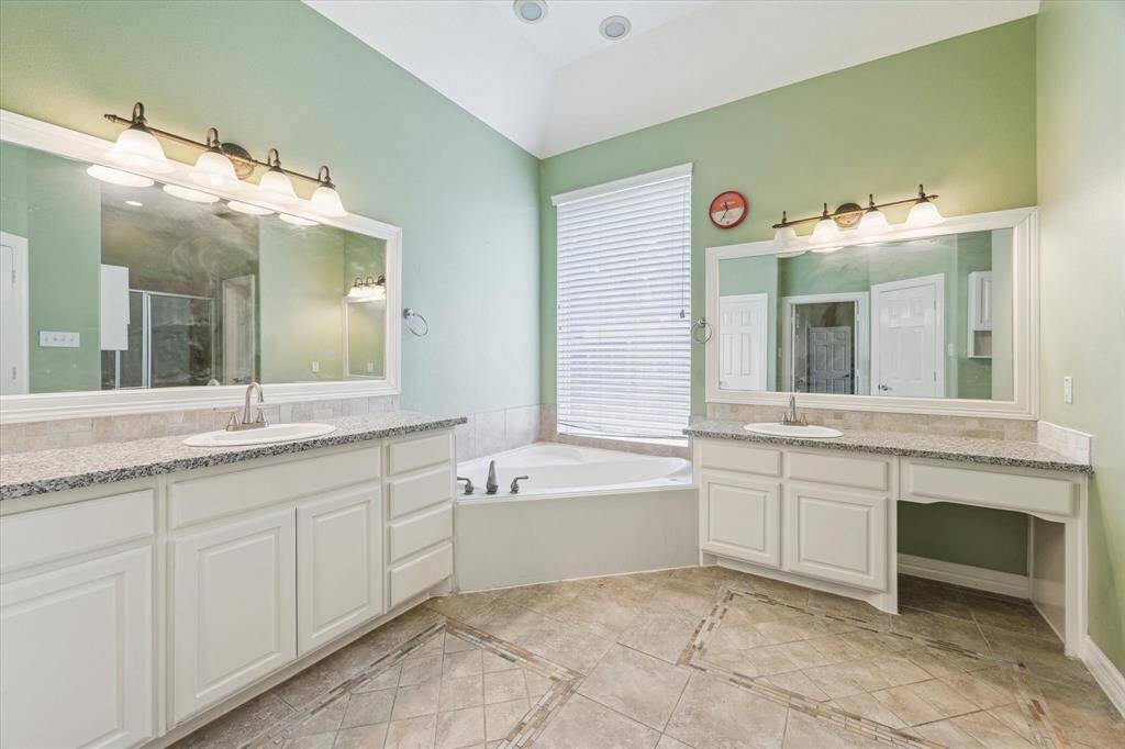 Master Baths With His and Her vanity with new granite counter top and faucet.