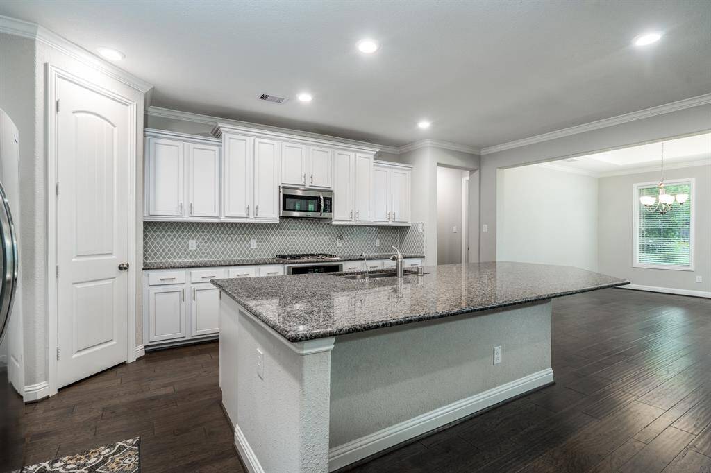 Island kitchen has granite, stainless appliances and gas cooktop.
