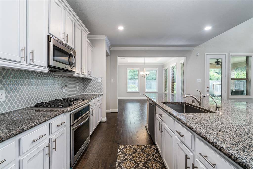 Kitchen is open to the dining area conveniently nearby.