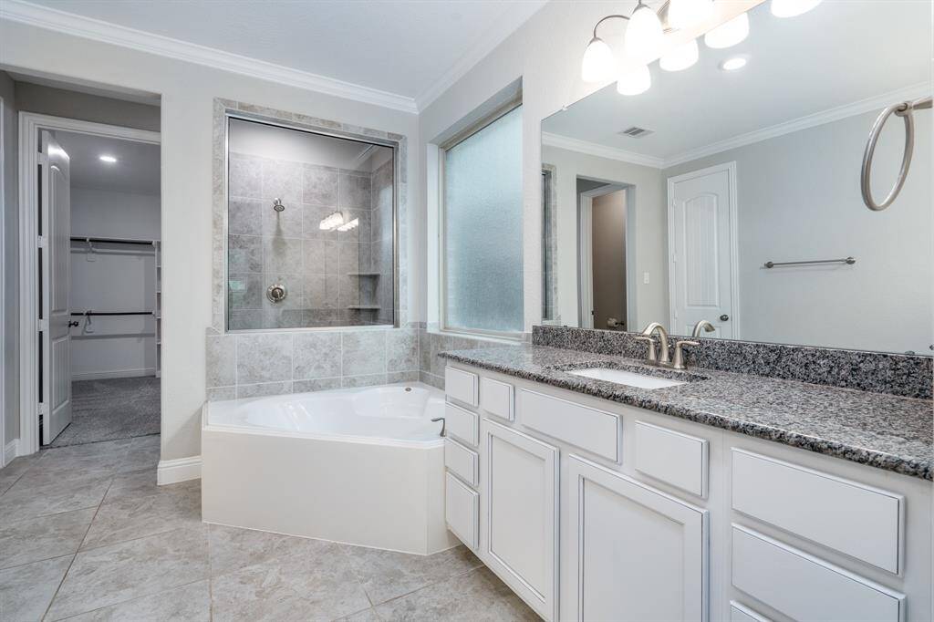 Spa like bath with large separate tub and walk-in shower.