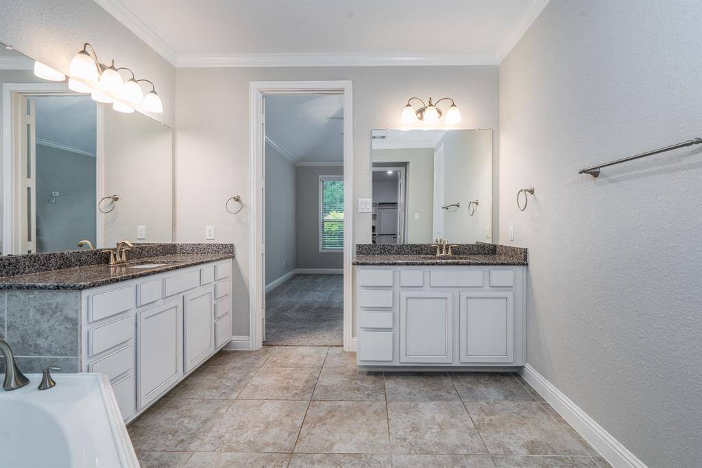 Dual granite vanities and tons of cabinet storage.