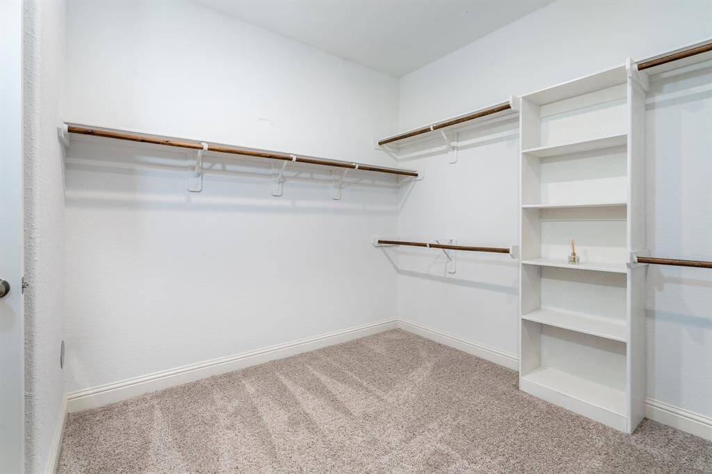 Walk-in closet with built-in shelving.