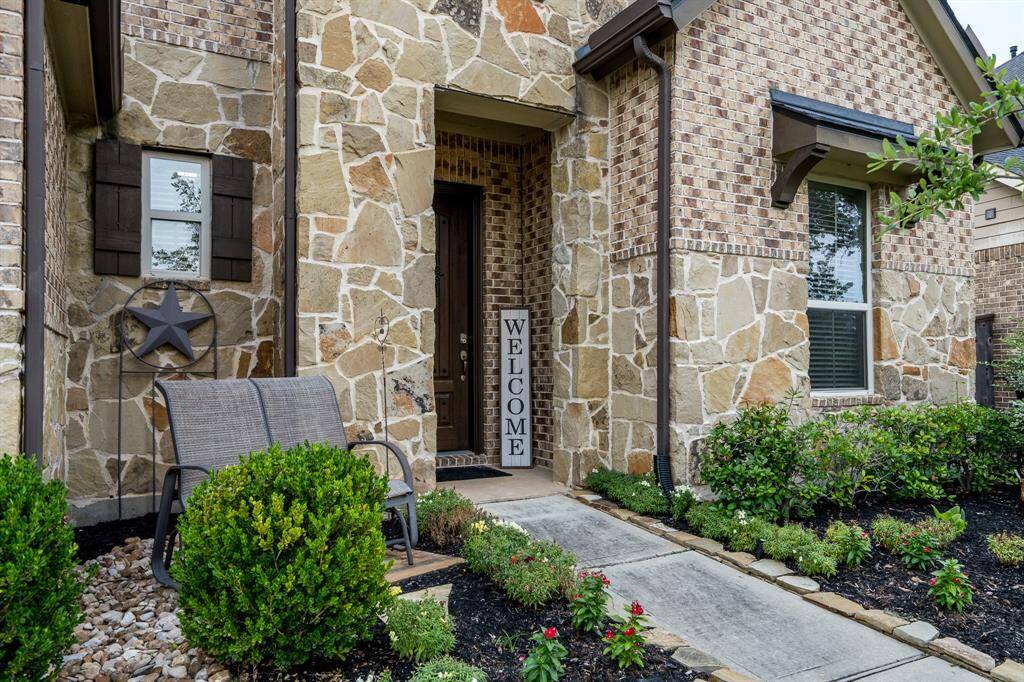 Walk up to your home noticing there are also gutters and updated landscaping.