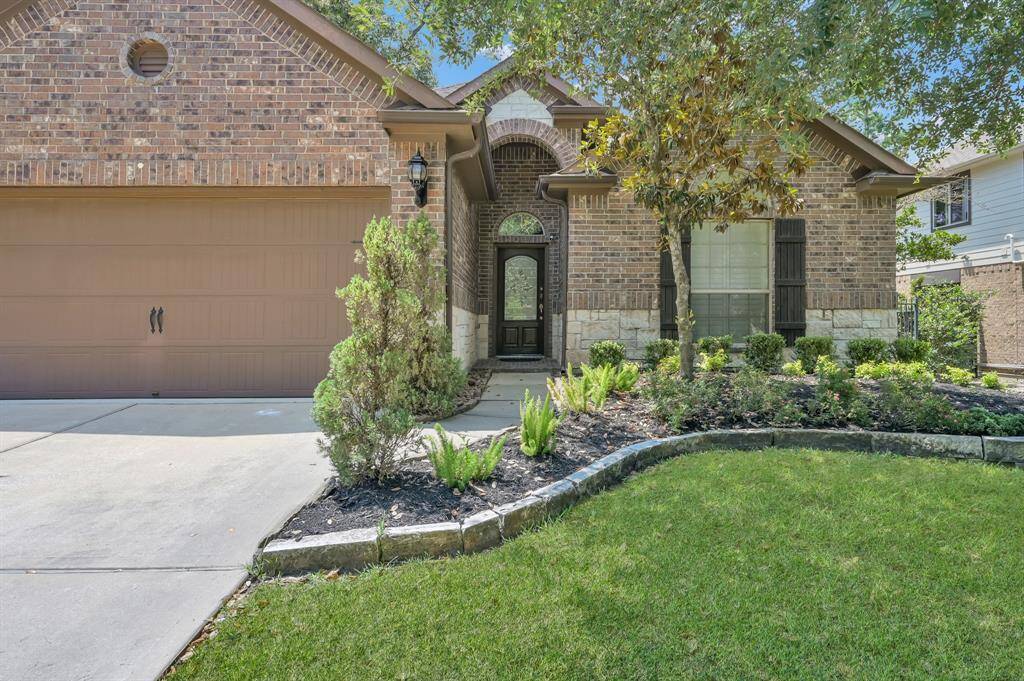 Updated landscaping with stone surround in the flower beds.