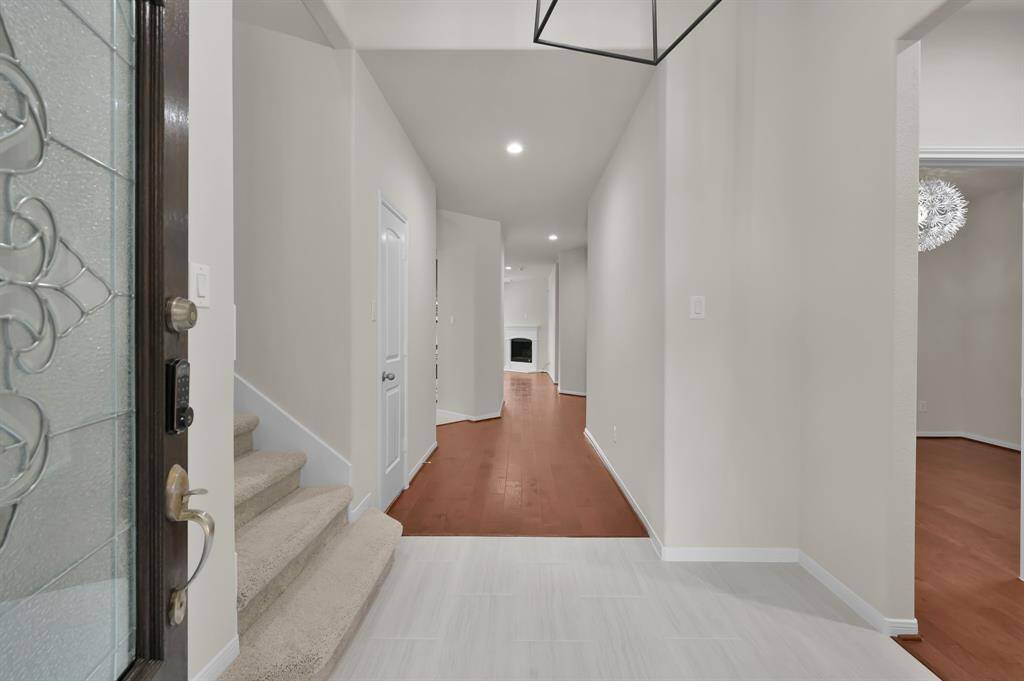 entry recently updated with brand new tile flooring, light fixture, and freshly painted