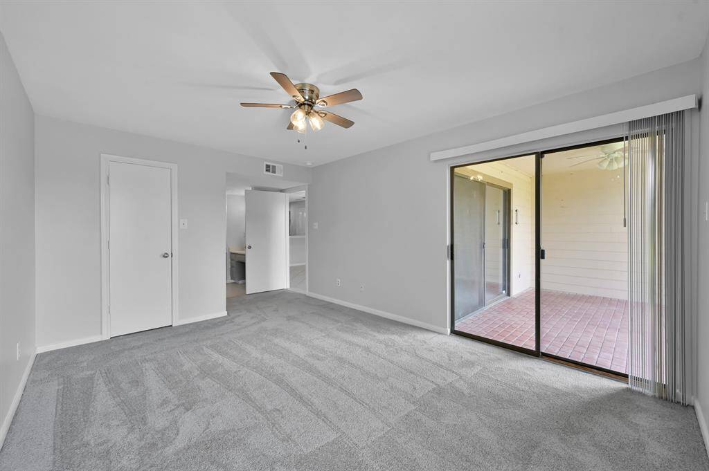 The main bedroom has another slider with access to the covered patio. It has a large walk in closet as well.