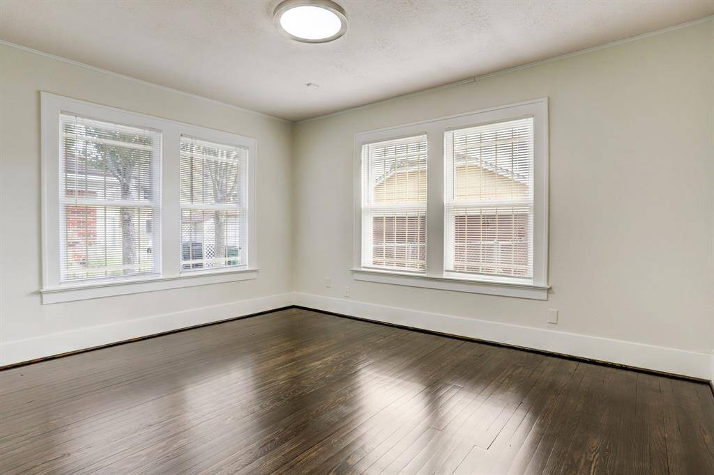 The rear bedroom overlooking the back yard. It has hardwood floors and plenty of natural light.