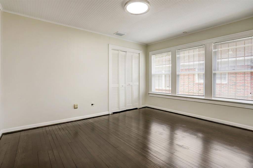 The Middle bedroom also has hardwood floors and a wall of windows.