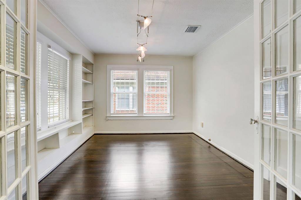 The bonus room would make a great home office or study with its built-in book cases and French doors for privacy.  It has a closet so it could also be used as a third bedroom.