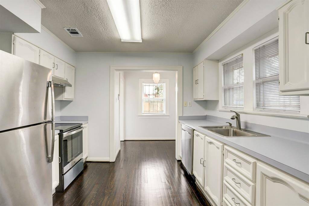The kitchen has plenty of cabinet and counter space. Through the case opening is a charming breakfast nook area!