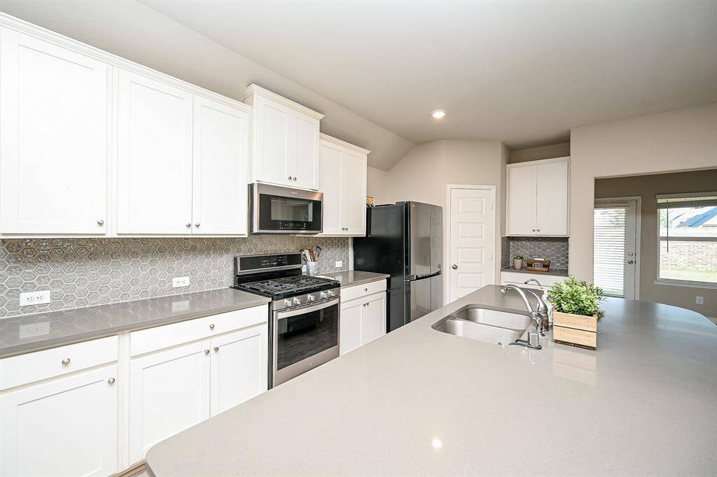 The spacious island offers ample counter space, perfect for meal prep and entertaining.