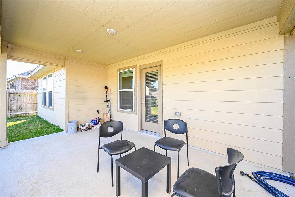 Covered back patio offers a cozy outdoor space for relaxation or entertainment.