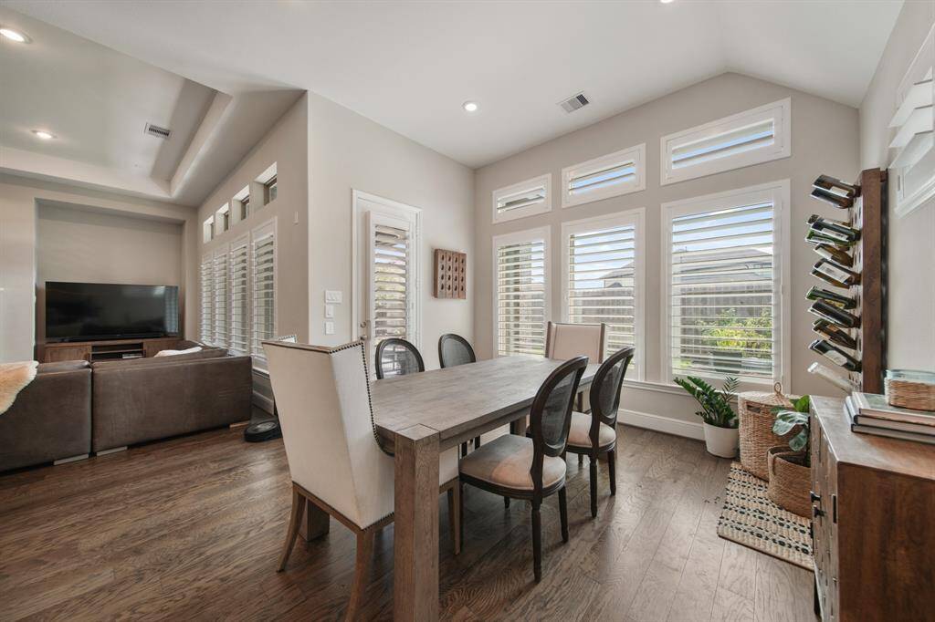 The elegantly designed dining area flows effortlessly into the kitchen and living room, offering a spacious setting for a grand dining table—perfect for sophisticated gatherings and intimate family meals.