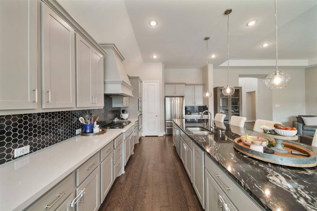 Rich cabinetry offers a clean, timeless aesthetic that elevates the space with a sense of brightness and openness.