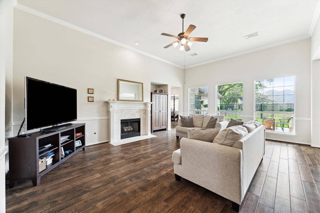 Gather and relax in the spacious family room, with soft neutral tones, and a gas-log fireplace create a cozy, inviting atmosphere, ideal for quiet evenings or lively gatherings with family and friends.