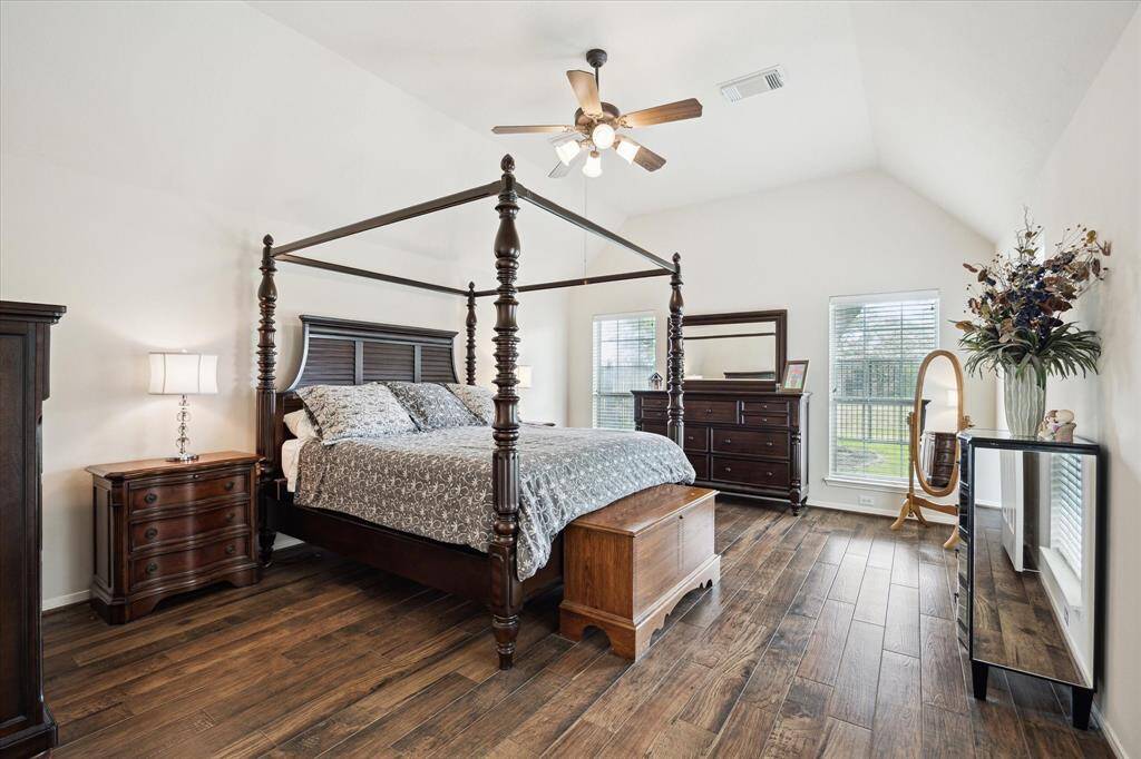Escape to your private owner's retreat featuring rich wood-look tile flooring, soft natural light, and plenty of space to unwind. This serene suite includes a large walk-in closet and a spa-like ensuite bathroom designed for comfort and relaxation.