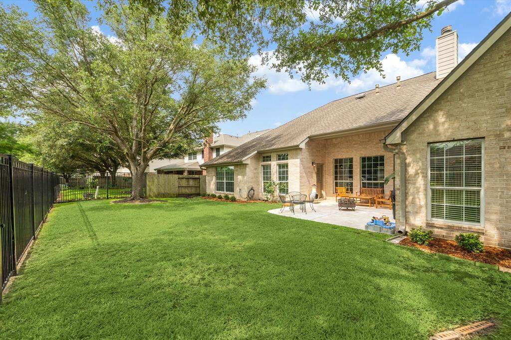 Expansive and private, this backyard provides ample space for pets, play, or future outdoor upgrades, all nestled beneath the shade of mature trees with picture-perfect views of the lake.