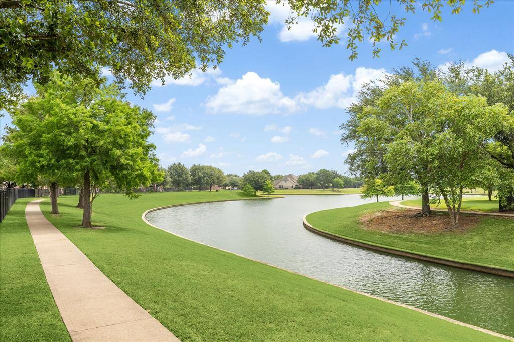 A private back gate provides easy access to the scenic trail system that connects to neighborhood lakes, parks, and pools. The lake is stocked with bass and catfish, and long-time residents say tilapia were introduced decades ago when a nearby fish farm overflowed into Cypress Creek. Fishing is a popular pastime, and it's common to see neighbors casting a line.