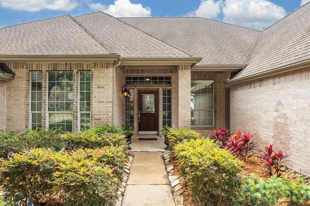 A beautifully landscaped front yard and an impressive covered front porch offer a warm welcome to all who enter this charming home.