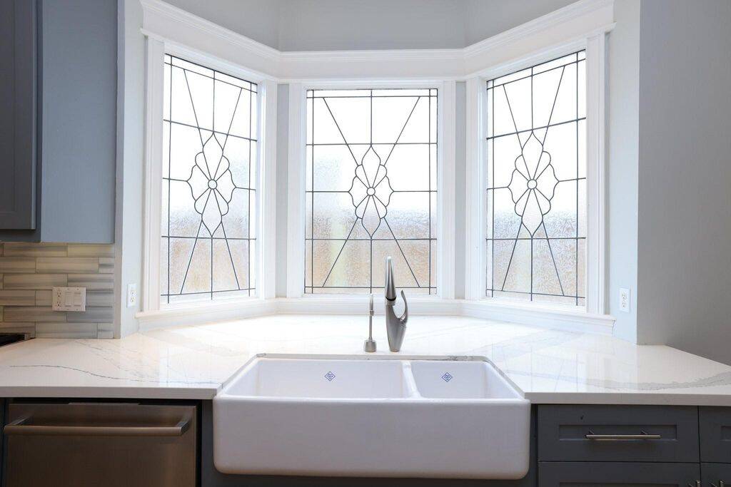 Period stained glass windows can be found around several corners adding to the Heights charm! This large farm sink is great for the chef in the home!