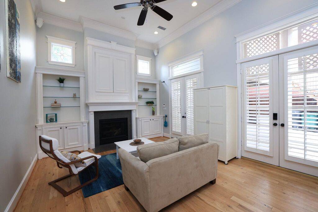 The private family room is also large with 2 sets of French doors and transom windows. Above the 2nd fireplace the doors open to reveal a place to put a TV.