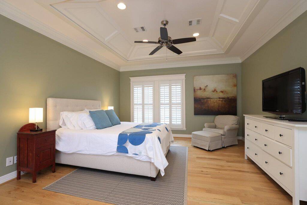 Peaceful primary bedroom measures 25x14 with sleeping area on one side and sitting area on the other.