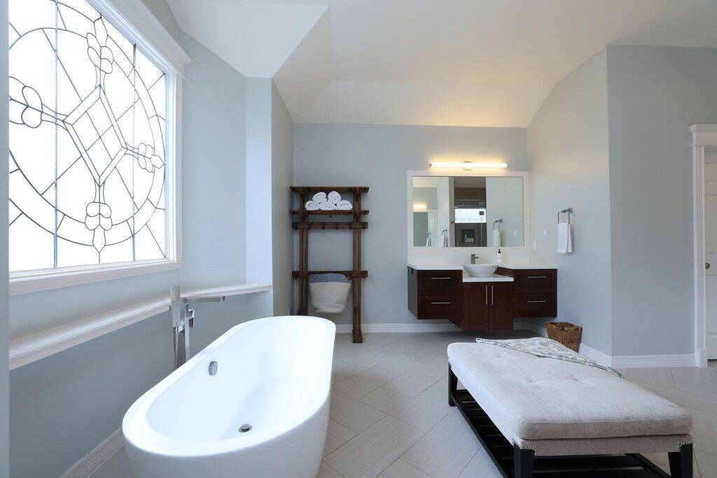 Imaging soaking in this beautiful tub next to this leaded glass window amongst these peaceful colors!