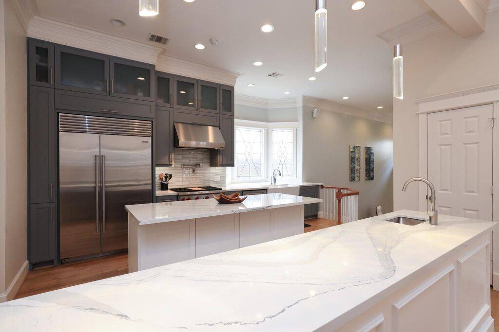 Modern kitchen has both a bar and an island with seating. Also a 2nd sink and a pot filler for the chef within you!