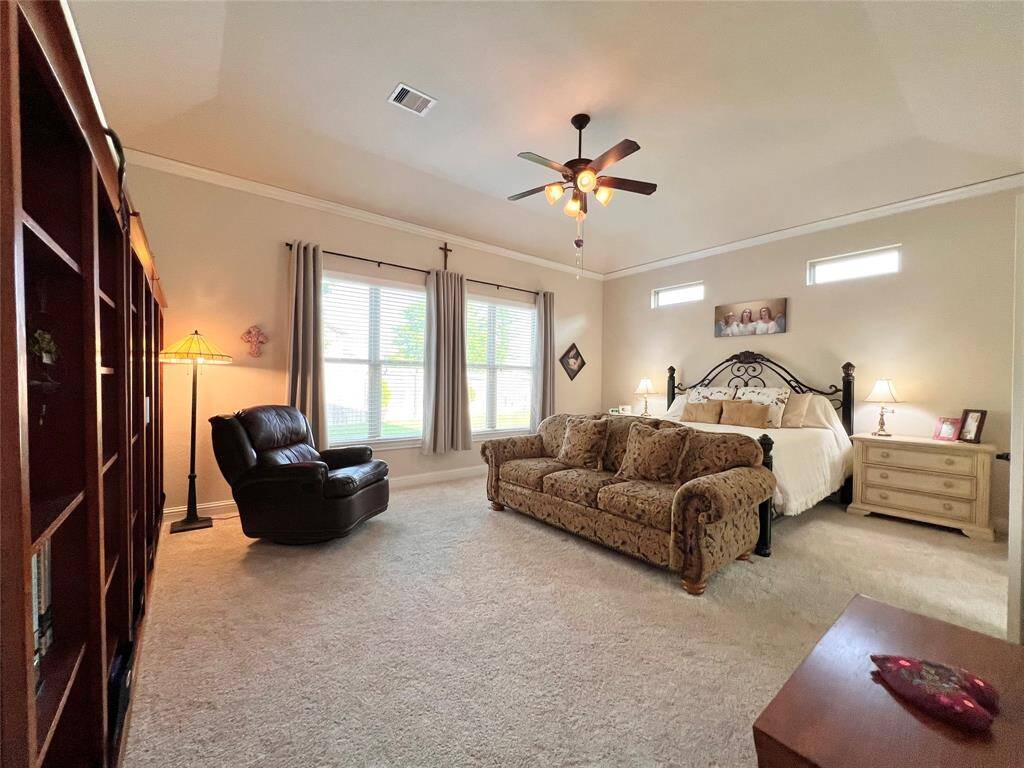 GENEROUSLY SIZED PRIMARY SUITE, SWEET!UPDATED CARPET, TRAYED CEILING, AND TRANSOM WINDOWS MAKE THIS OWNERS RETREAT SOMETHING SPECIAL.