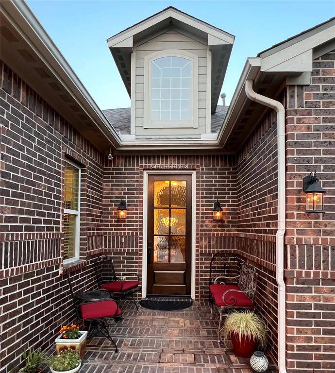 CLASSIC BRICK HOME ELEGANTLY ACCENTED WITH NEWLY UPGRADED GLASS DOOR AND A PERFECT PORCH.