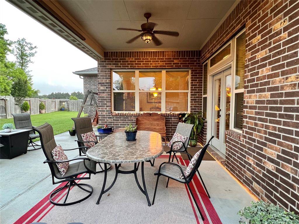 COVERED PATIO WITH CEILING FAN, PERFECT FOR RELAXING WITH YOUR MORNING COFFEE OR OUTDOOR DINING AND ENTERTAINING.