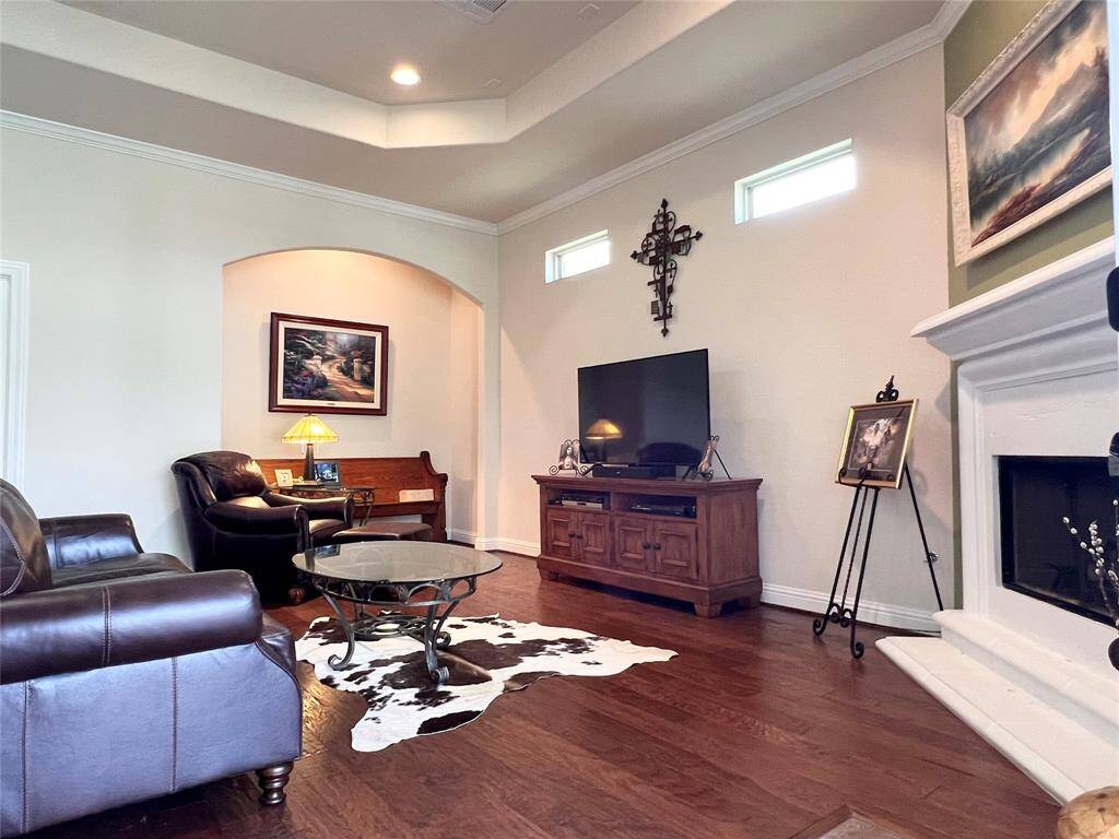 THE SECOND HALF OF THE FAMILY ROOM IS USED IN A MORE TRADITIONAL WAY WITH THE TV SET CENTER STAGE.  ROOM IS ACCENTED BY EXTENDED ALCOVE AND TRANSOM WINDOWS,