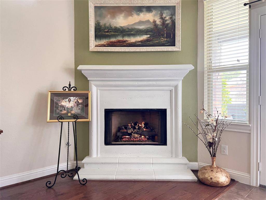 DON'T LET THE TV STEAL THE SHOW, THE GAS FIREPLACE IS A SHOWPIECE.  FRENCH DOORS TO THE REAR PATIO PROVIDE GREAT NATURAL LIGHT. THERE IS ALSO A CEILING FAN.